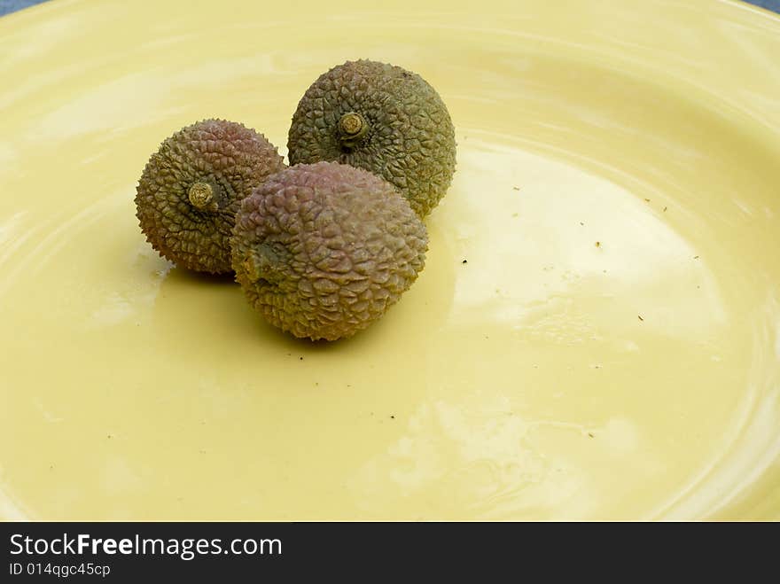 Photograph of  three lychee's on a cloudy day.