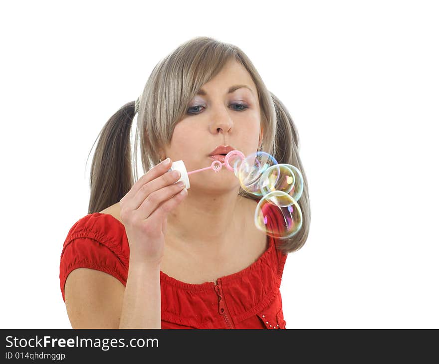 Blonde girl blowing bubbles isolated on white