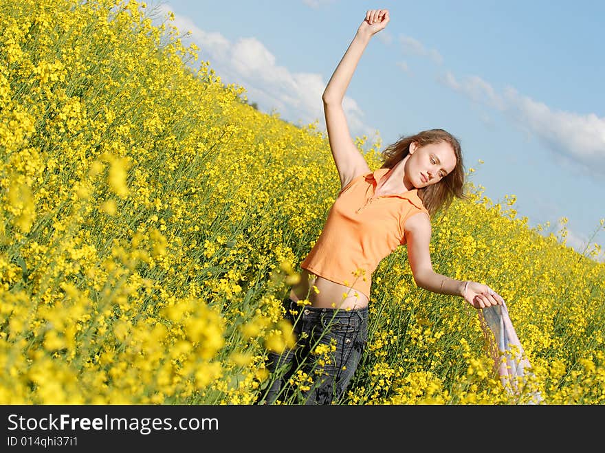 Pleasure of the beautiful girl on a background of a yellow field