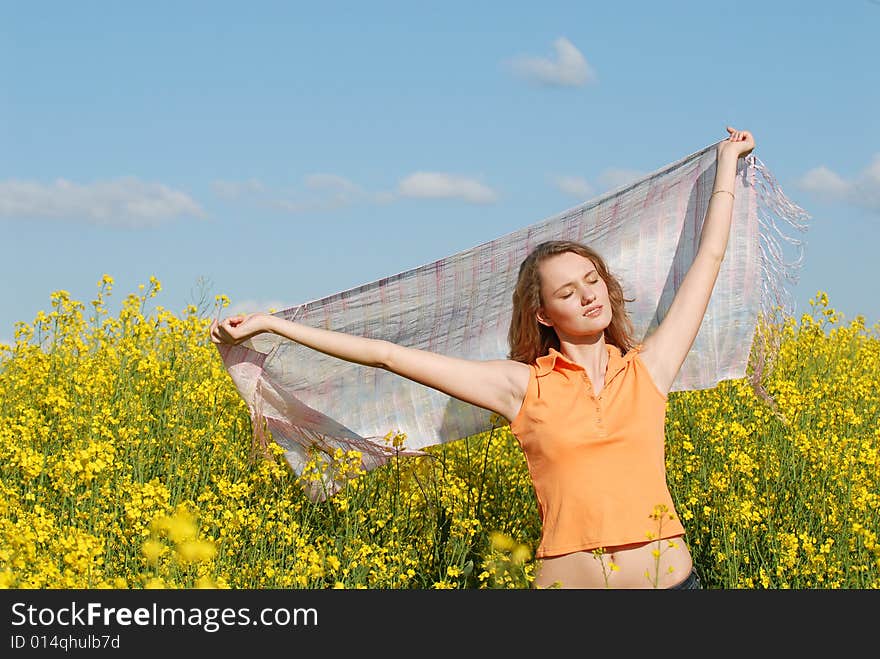 Pleasure of the beautiful girl on a background of a yellow field