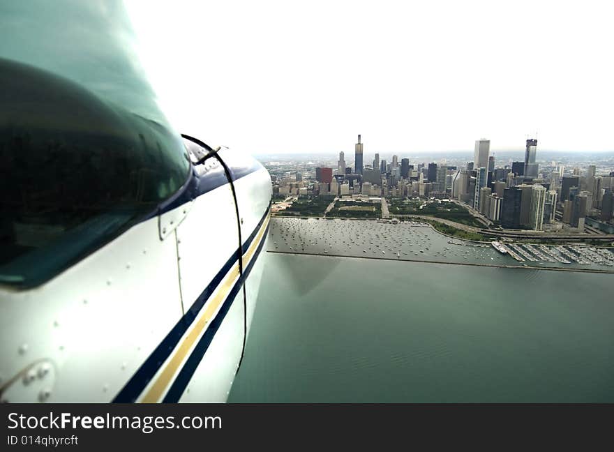 Airplane flying over water approaching a city. Airplane flying over water approaching a city