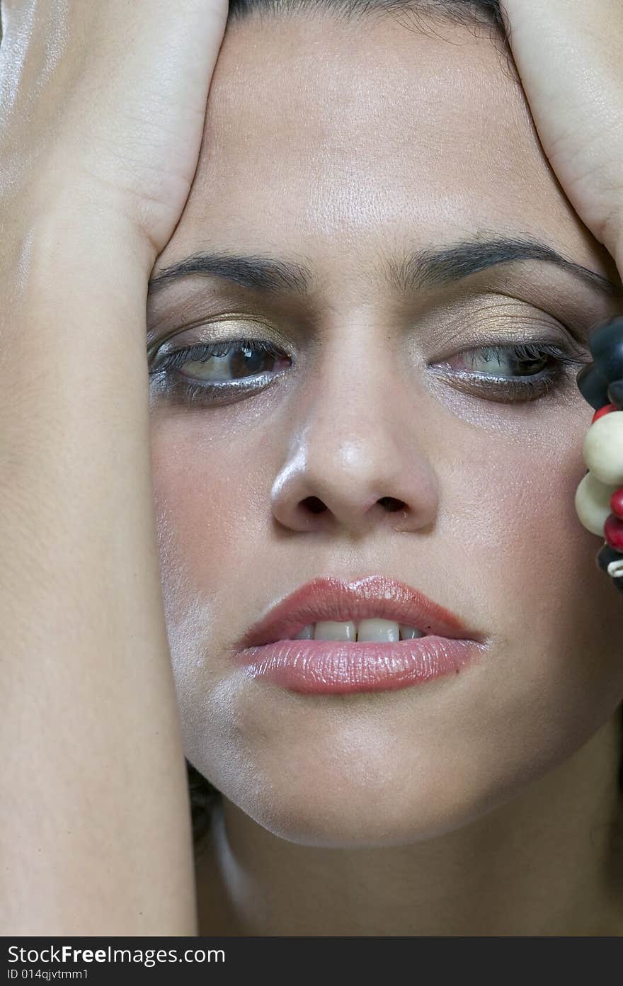 Worried woman holding head between her hands. Worried woman holding head between her hands