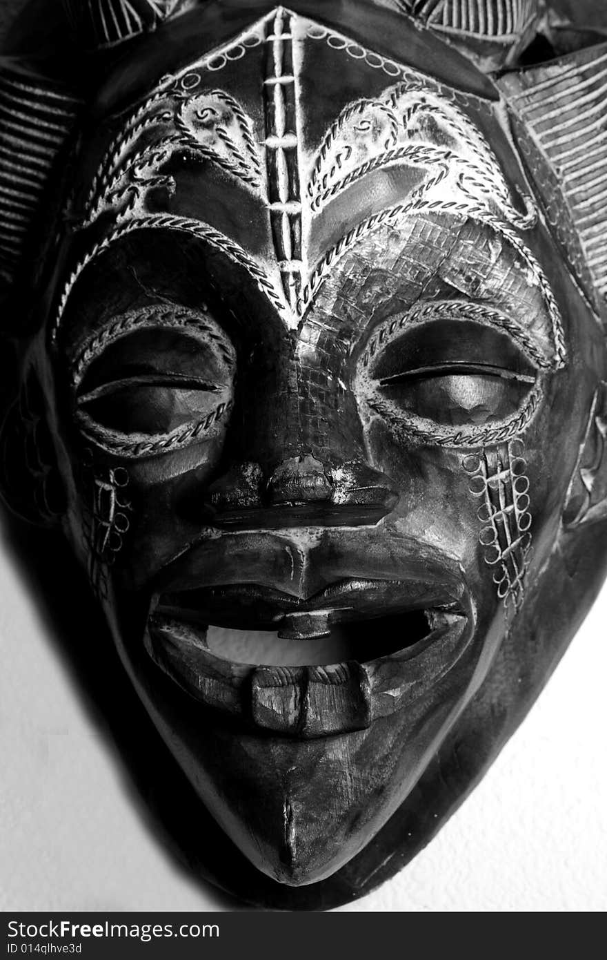 Black and White shot of a hand carved African Mask.