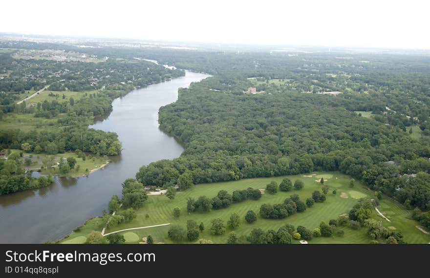 Overlooking lush green trees and land near a body of water. Overlooking lush green trees and land near a body of water