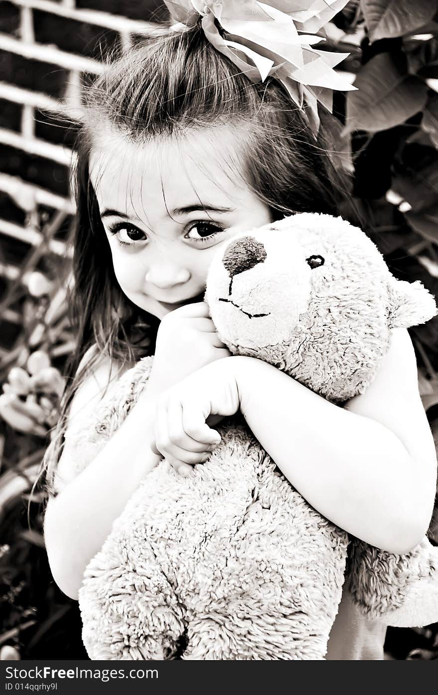 Beautiful young girl posing with her best friend, her Teddy Bear, in an outdoor setting. Beautiful young girl posing with her best friend, her Teddy Bear, in an outdoor setting.