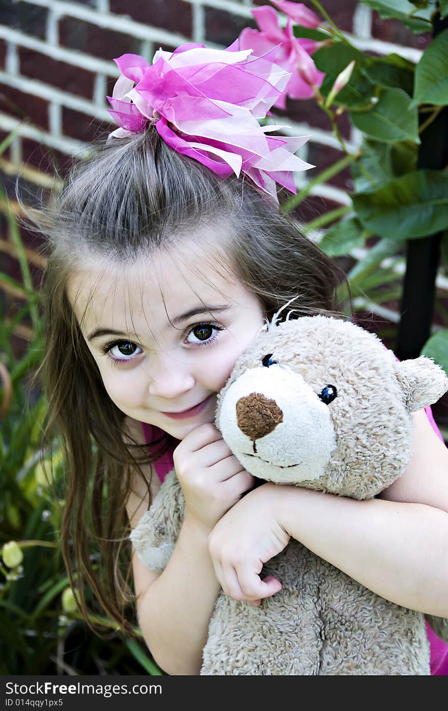 Beautiful Little Girl with her best friend, her teddy bear, in an outdoor setting. Beautiful Little Girl with her best friend, her teddy bear, in an outdoor setting.