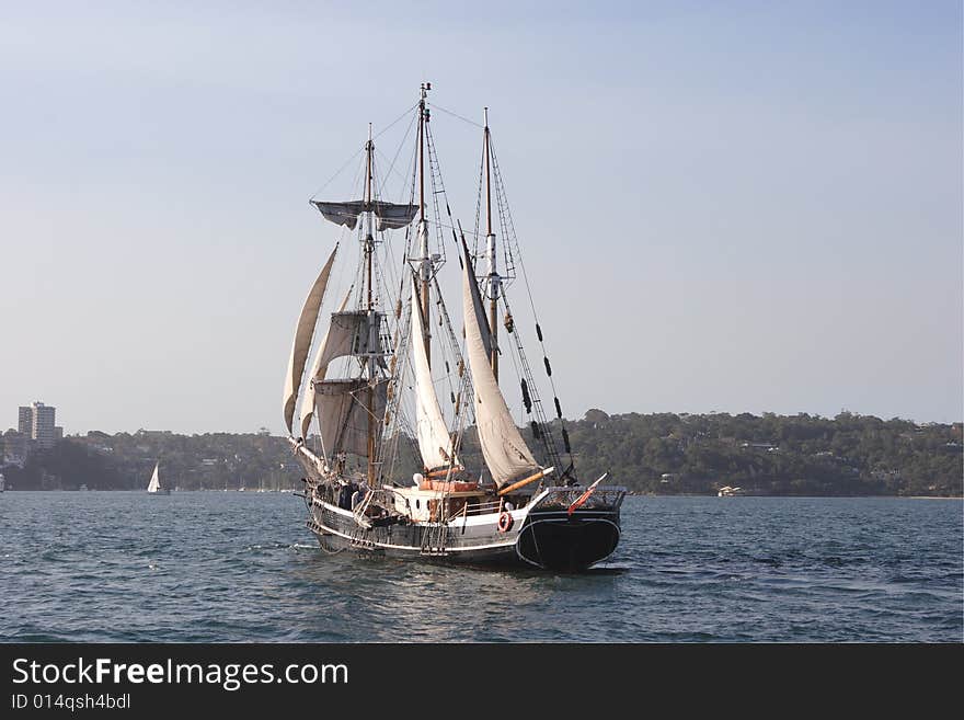 A barquentine sailing on the harbour