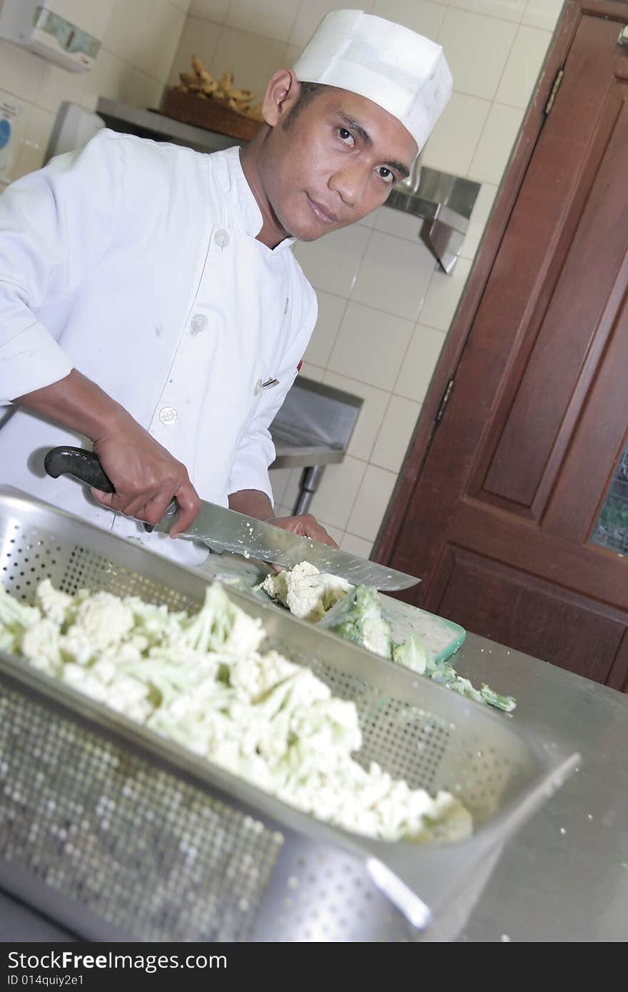 Photograph of chef cutting vegetable