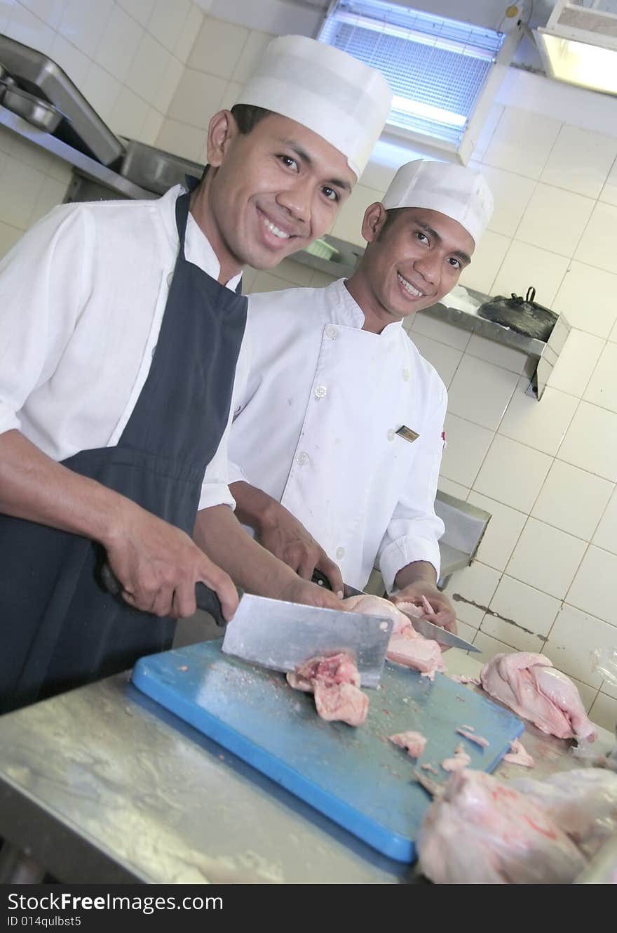 Chef at butcher, main focused on one of the man