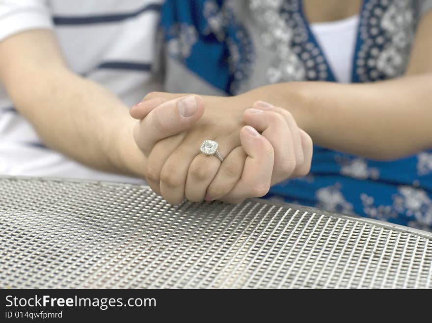 Close-up shot of engagement ring on woman's finger