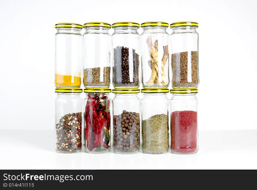 A row of spices on a white background