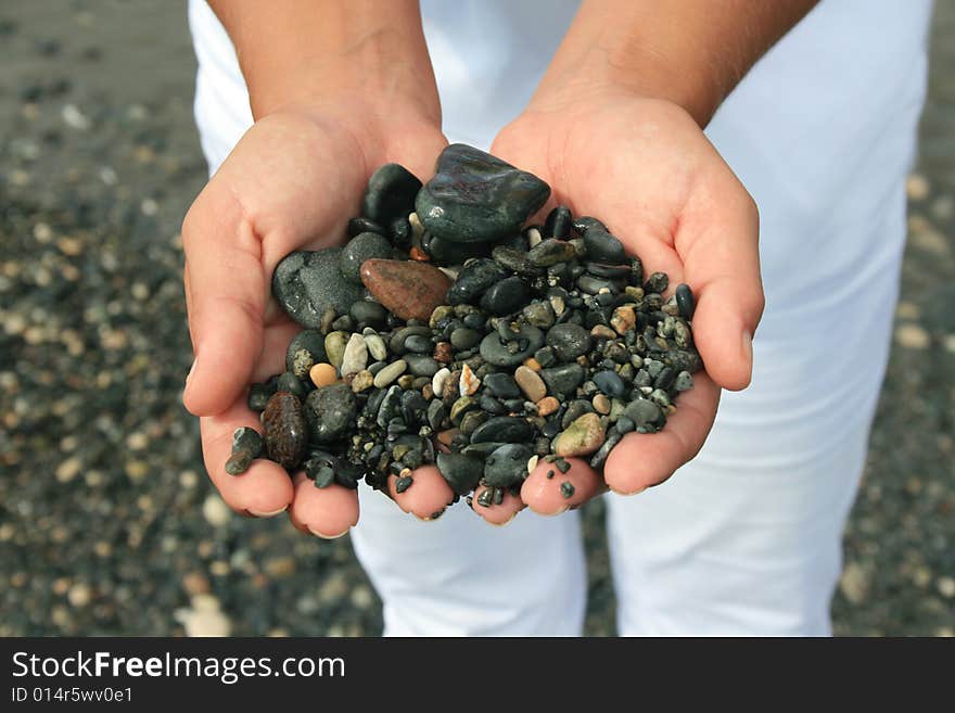 Closeup of hands holding pebbles. Closeup of hands holding pebbles