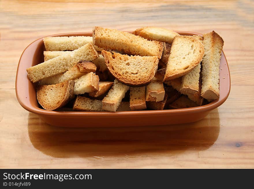 Crackers in brown bowl on wooden table