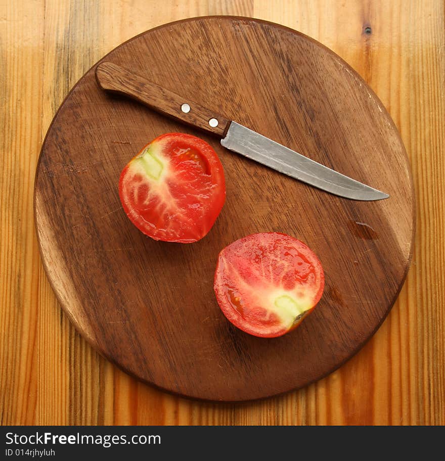 Fresh Tomato With Knife On Kitchen Board