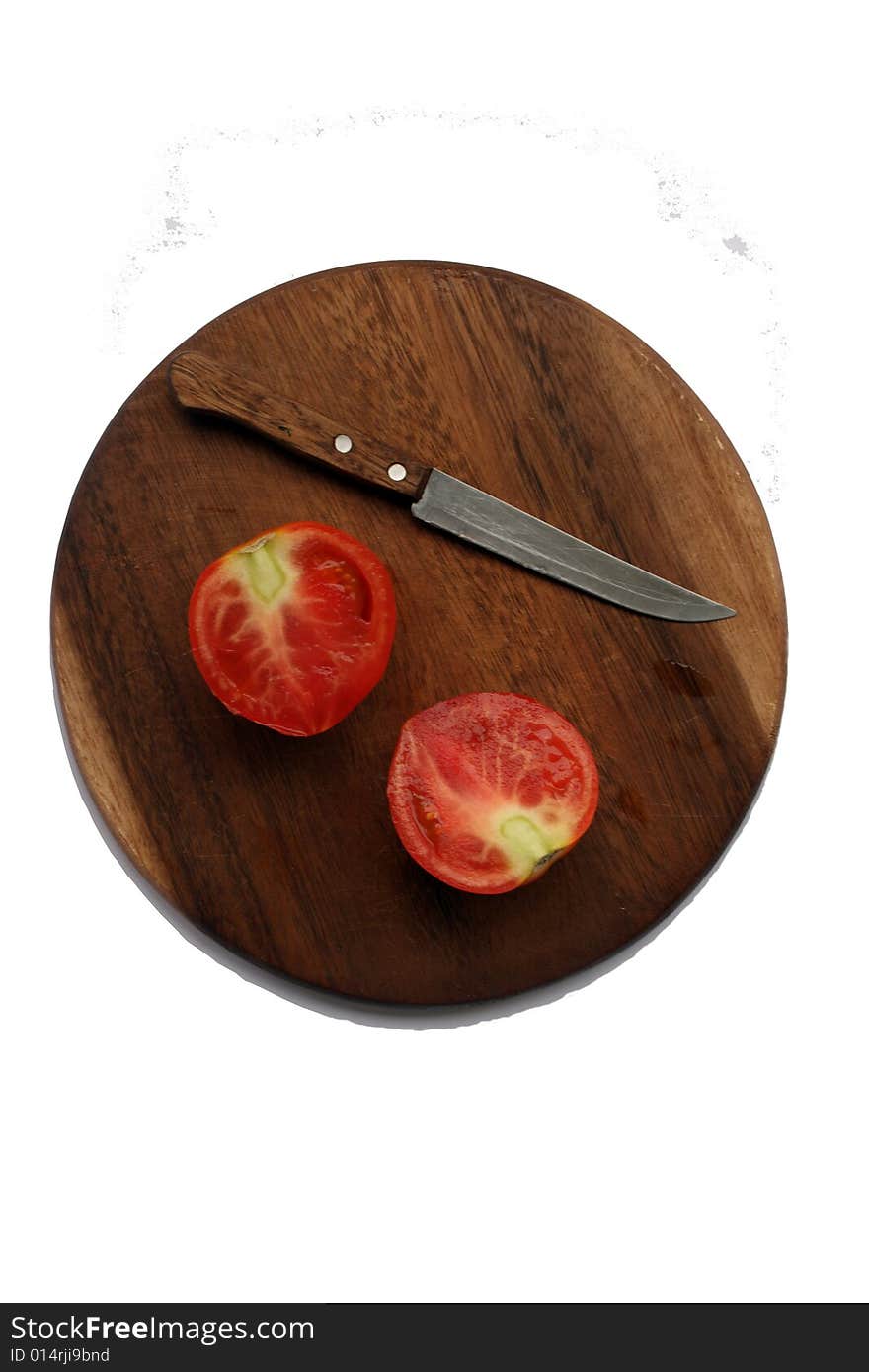 Fresh Tomato With Knife On Kitchen Board isolated on white