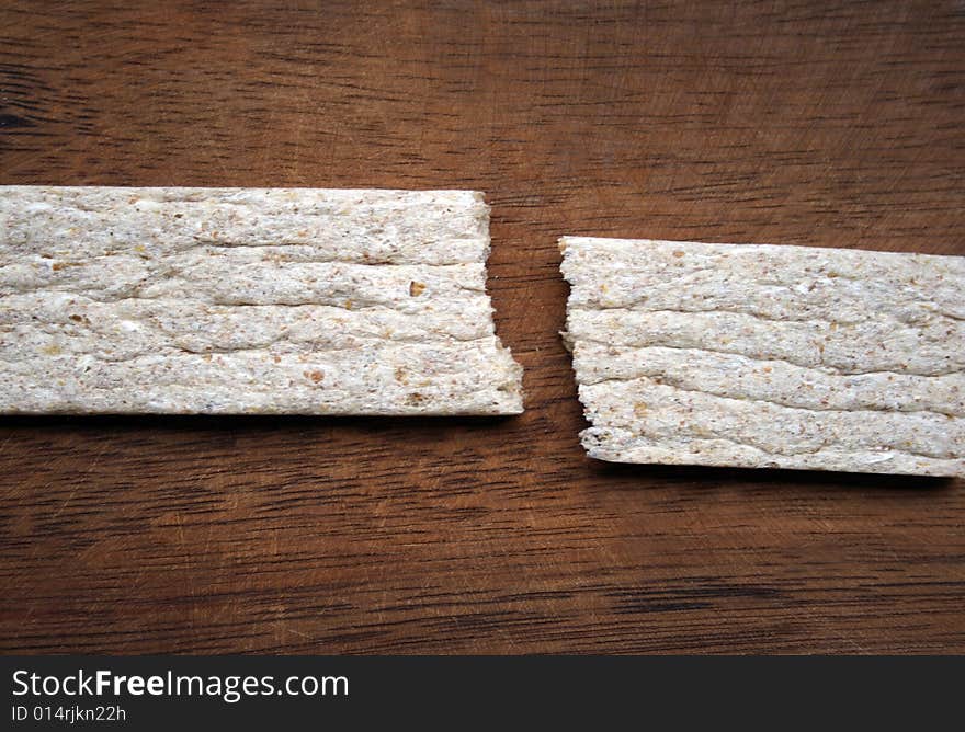 Crackers in brown bowl on wooden table. Crackers in brown bowl on wooden table