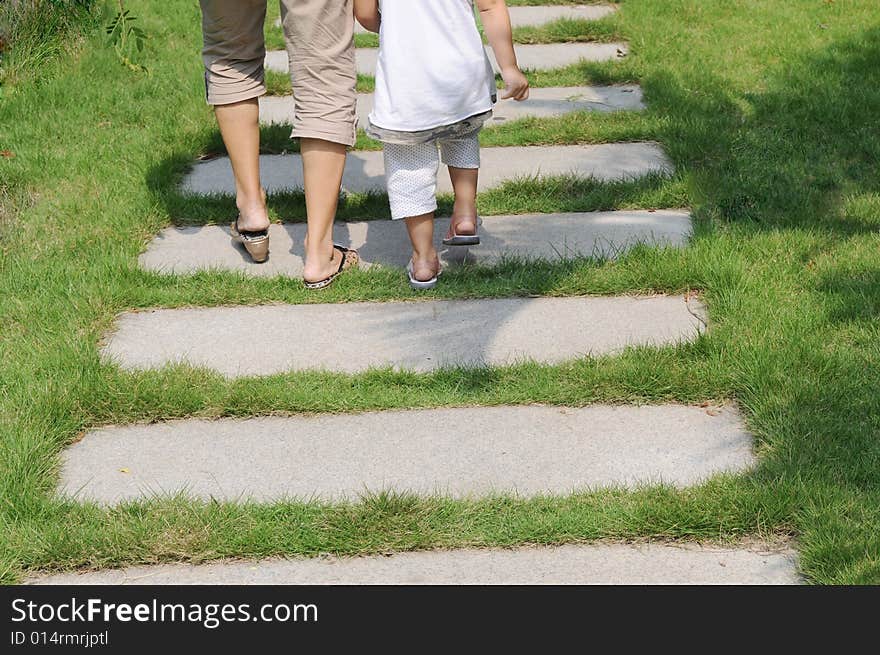 A toddler and his granny walk