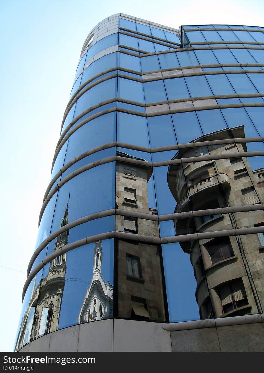 Reflection of the ancient house in a mirror wall of a modern building (Belgrade, Serbia)