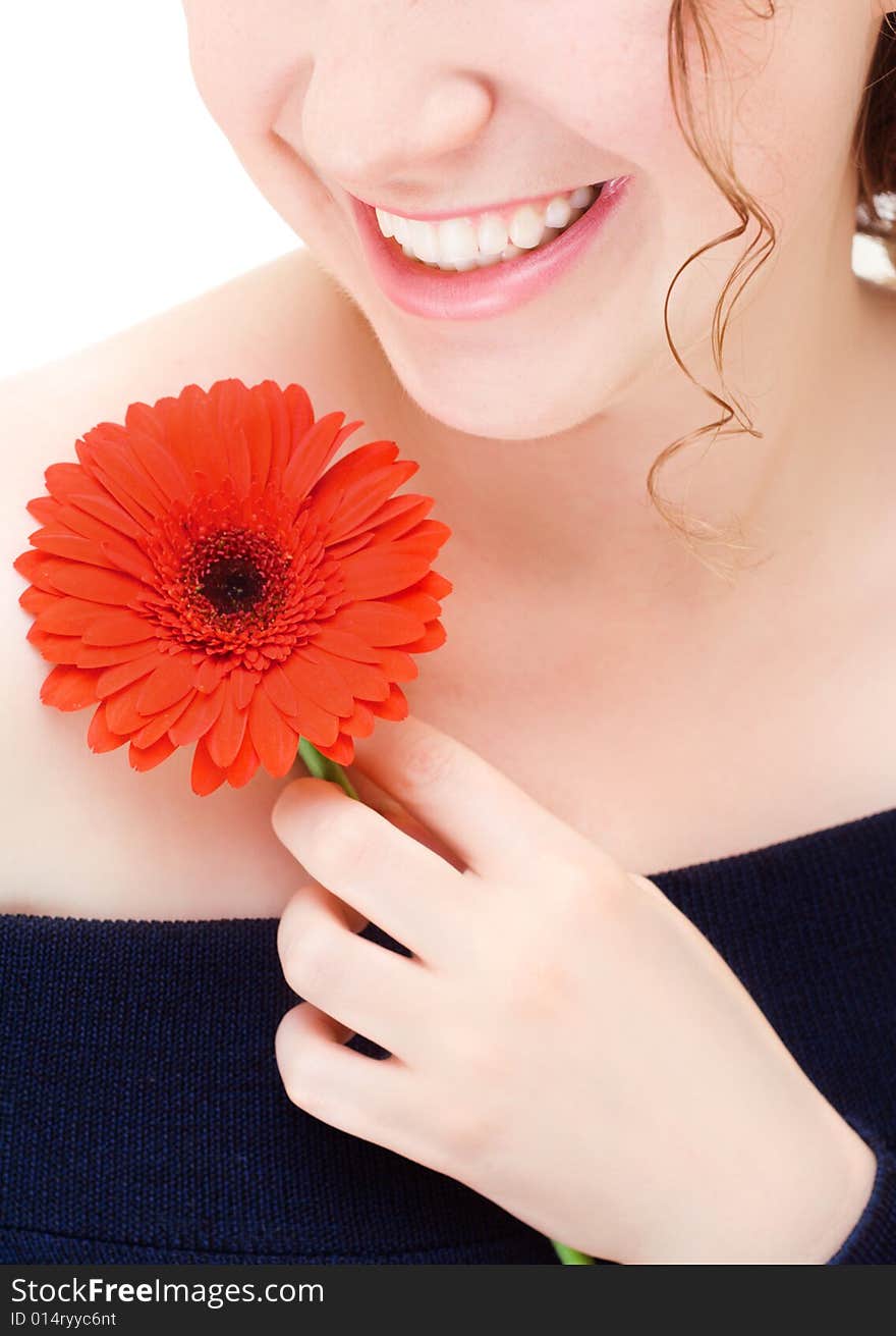 Young smiling woman with a red flower