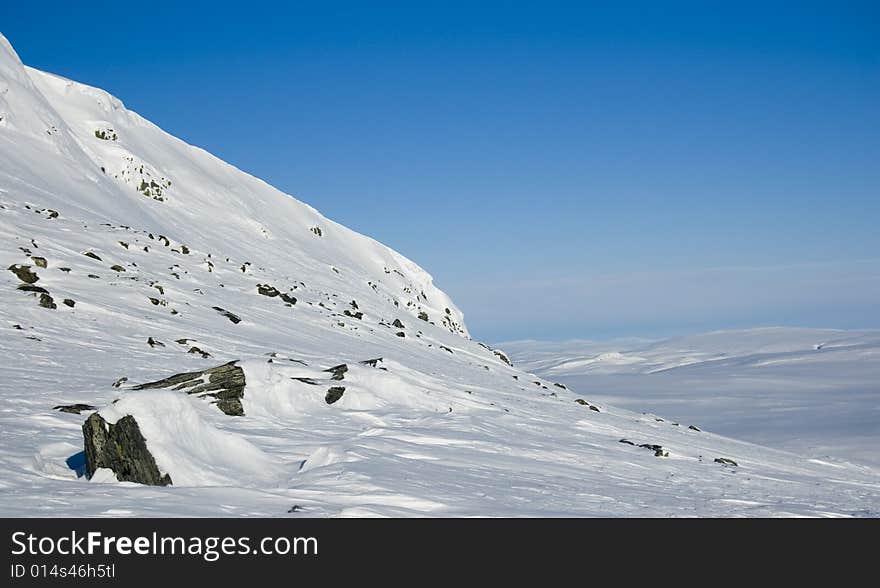 Wintry landscape with footprints leading from the foreground to the background. Wintry landscape with footprints leading from the foreground to the background