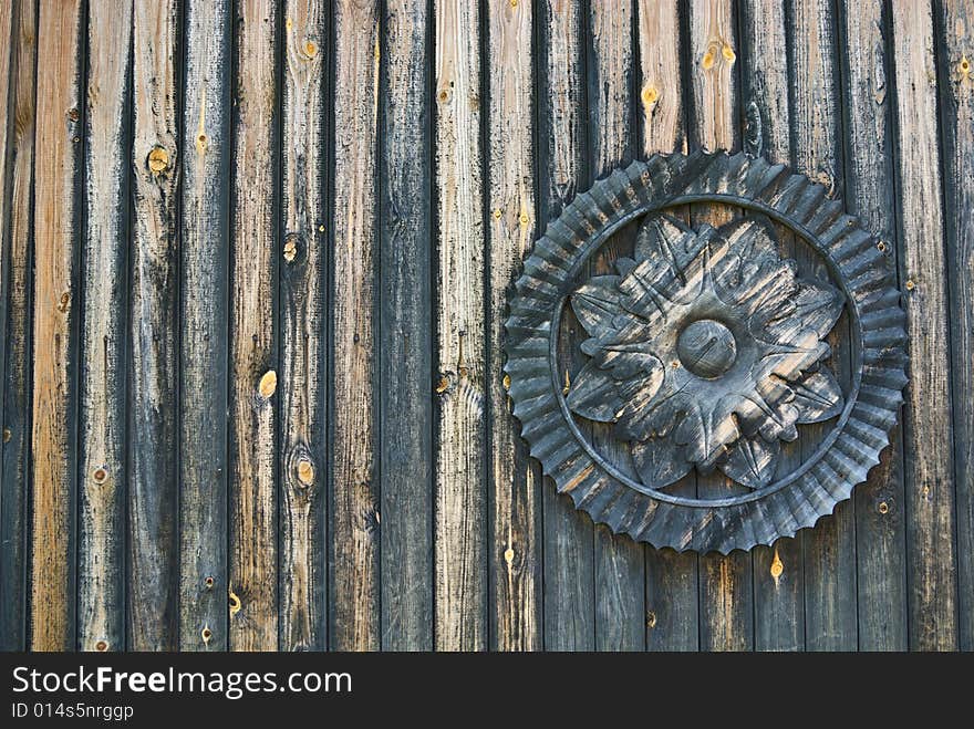 Wooden wall decorated with traditional flower-shape ornament. Wooden wall decorated with traditional flower-shape ornament