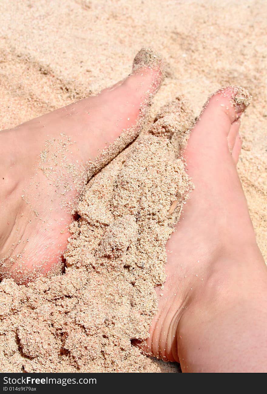 Foot in gold dust on the beach. Foot in gold dust on the beach