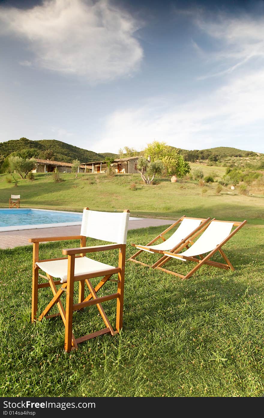 Chairs in the garden of a luxury country house in the famous tuscan hills, Italy. Chairs in the garden of a luxury country house in the famous tuscan hills, Italy.