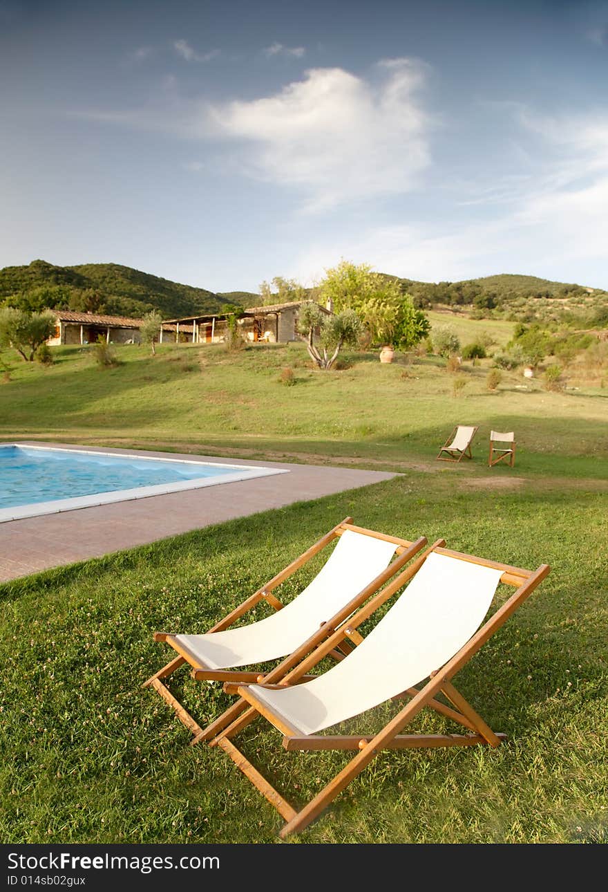 Chairs in the garden of a luxury country house in the famous tuscan hills, Italy. Chairs in the garden of a luxury country house in the famous tuscan hills, Italy.