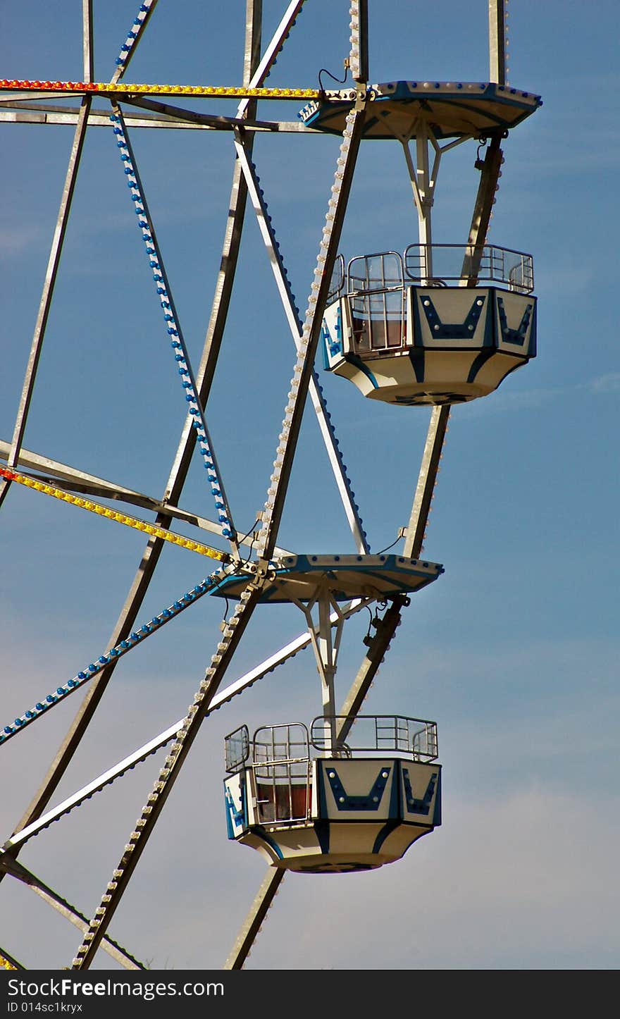 Cars of a large Ferris wheel await passengers. Cars of a large Ferris wheel await passengers.