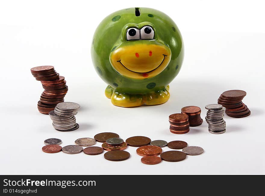 Piggy bank in the shape of a frog with piles of cash. Piggy bank in the shape of a frog with piles of cash