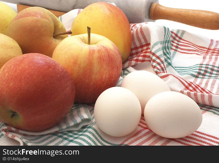 A couple of apple and eggs with a marble rolling pin. A couple of apple and eggs with a marble rolling pin.