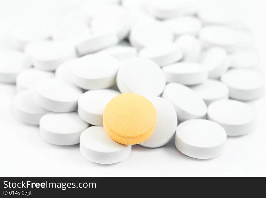 White and yellow pills isolated on white. White and yellow pills isolated on white