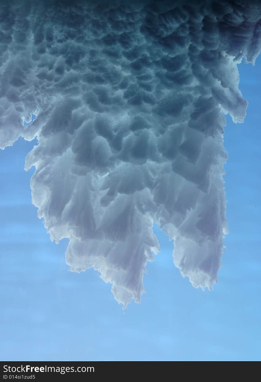 White snow scales in the form of leaves against the azure sky. White snow scales in the form of leaves against the azure sky