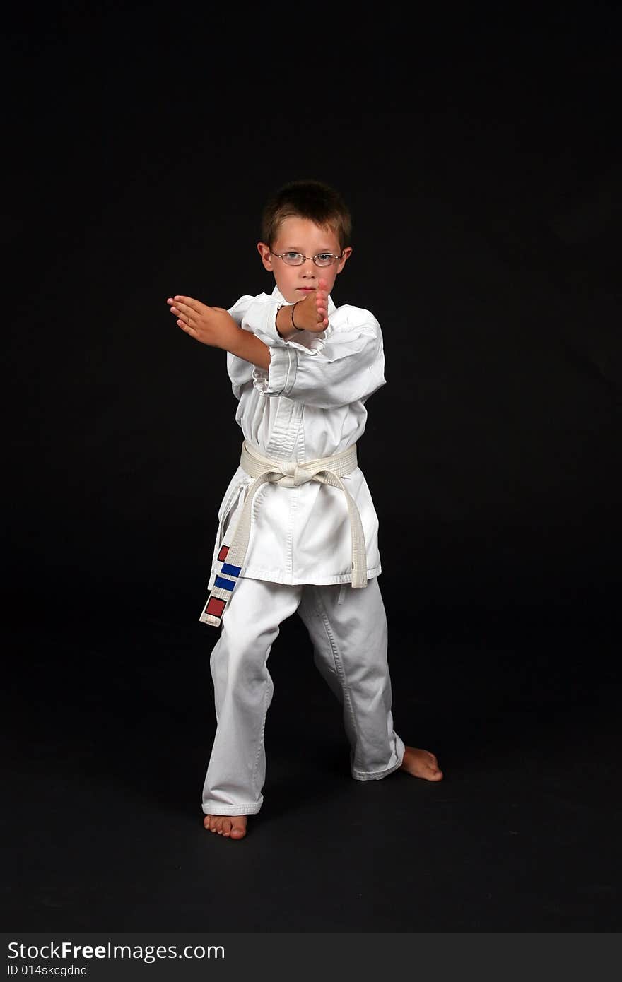 Traditional karate student demonstrating hand block and right stance. Traditional karate student demonstrating hand block and right stance