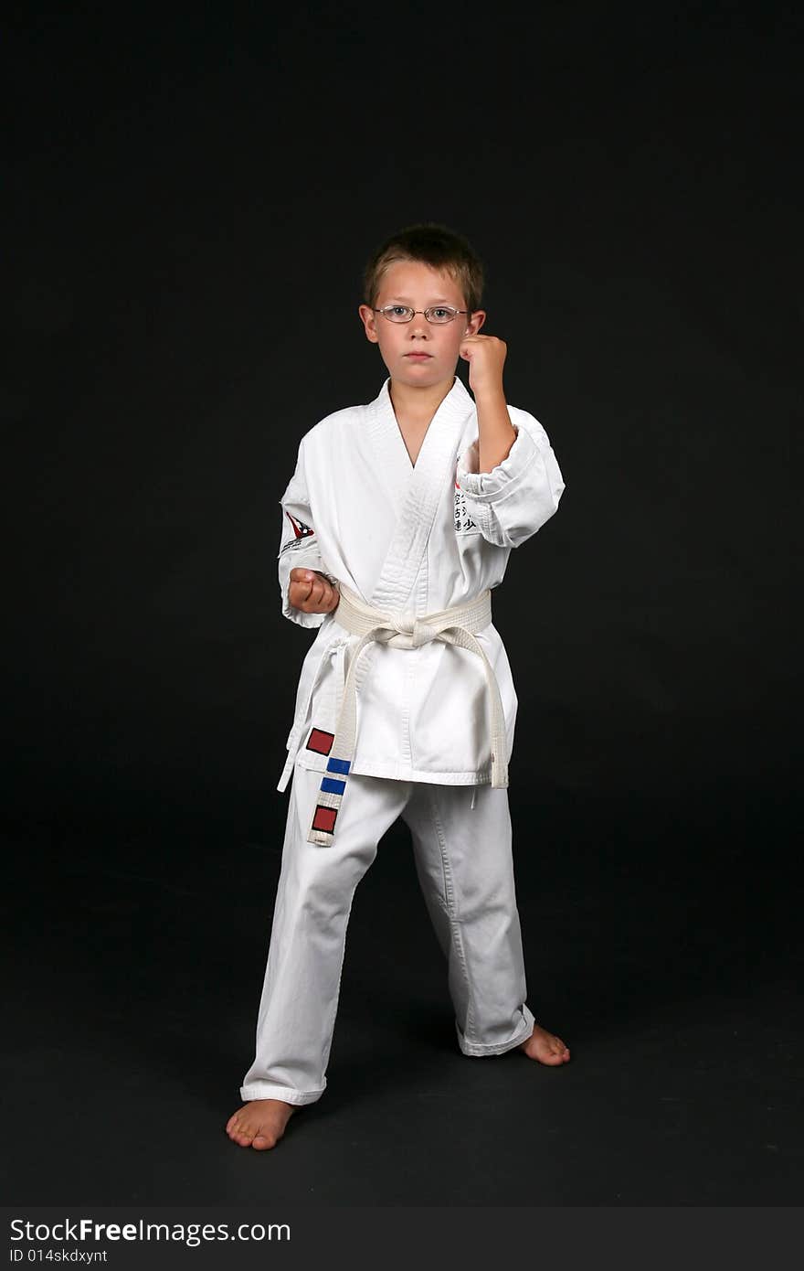 Traditional karate student demonstrates double bone block and right stance