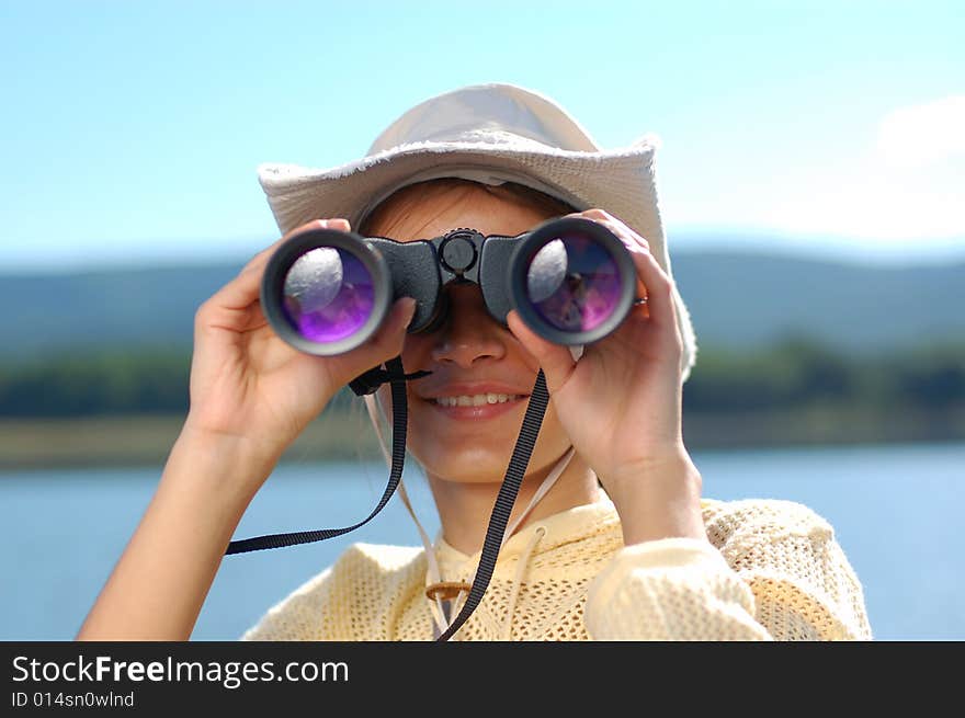 Woman with the binoculars over a mountains