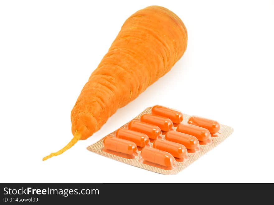 Vitamin pills with carrot on isolated white. Make your choice. Vitamin pills with carrot on isolated white. Make your choice