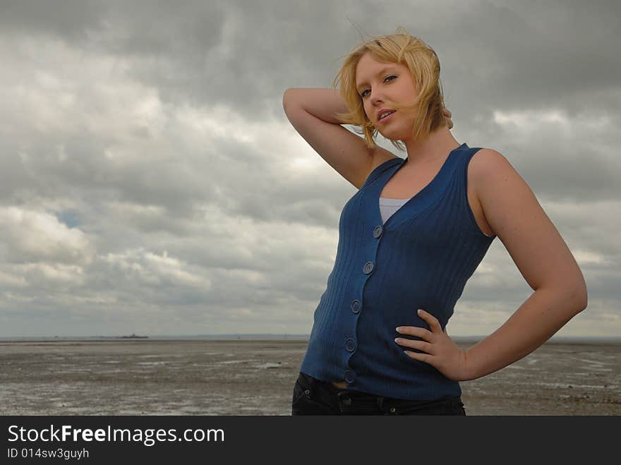 Pretty blond on stormy day at seaside