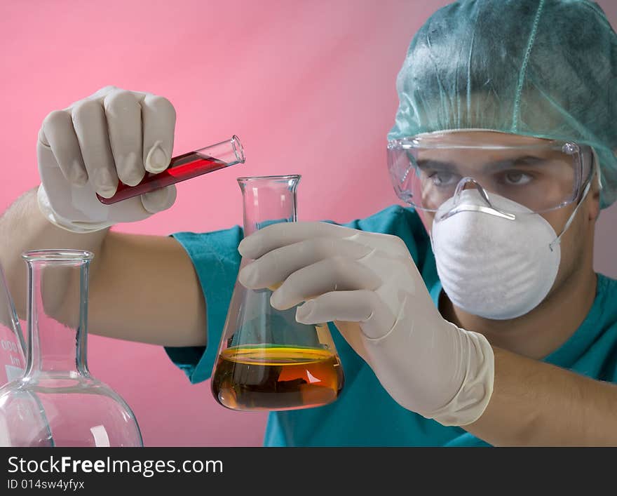 Young scientist working in a laboratory with mask. Young scientist working in a laboratory with mask