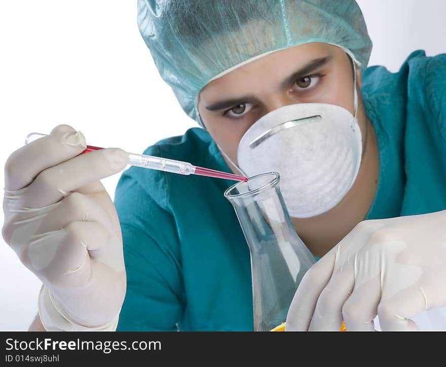 Scientist taking a probe in a labor scene with testtubes and beaker Shallow DOF the Focus is on the little bottle and the hand