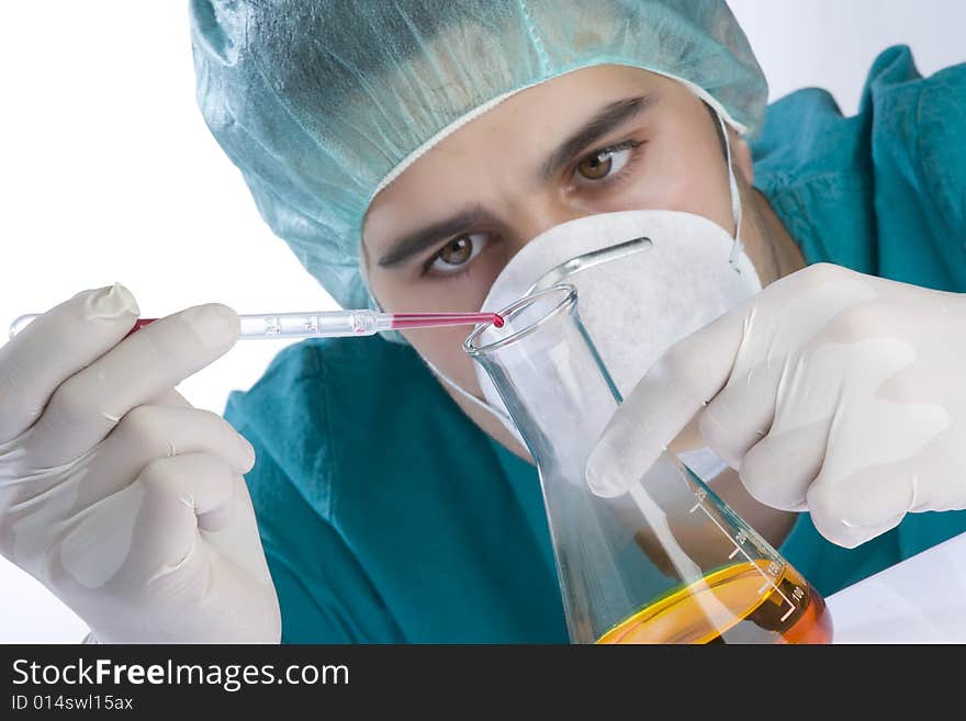 Scientist taking a probe in a labor scene with testtubes and beaker Shallow DOF the Focus is on the little bottle and the hand