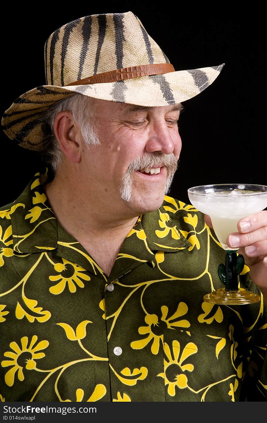 Okler man giving a toast with a frozen drink that he is obviously enjoying. Okler man giving a toast with a frozen drink that he is obviously enjoying.