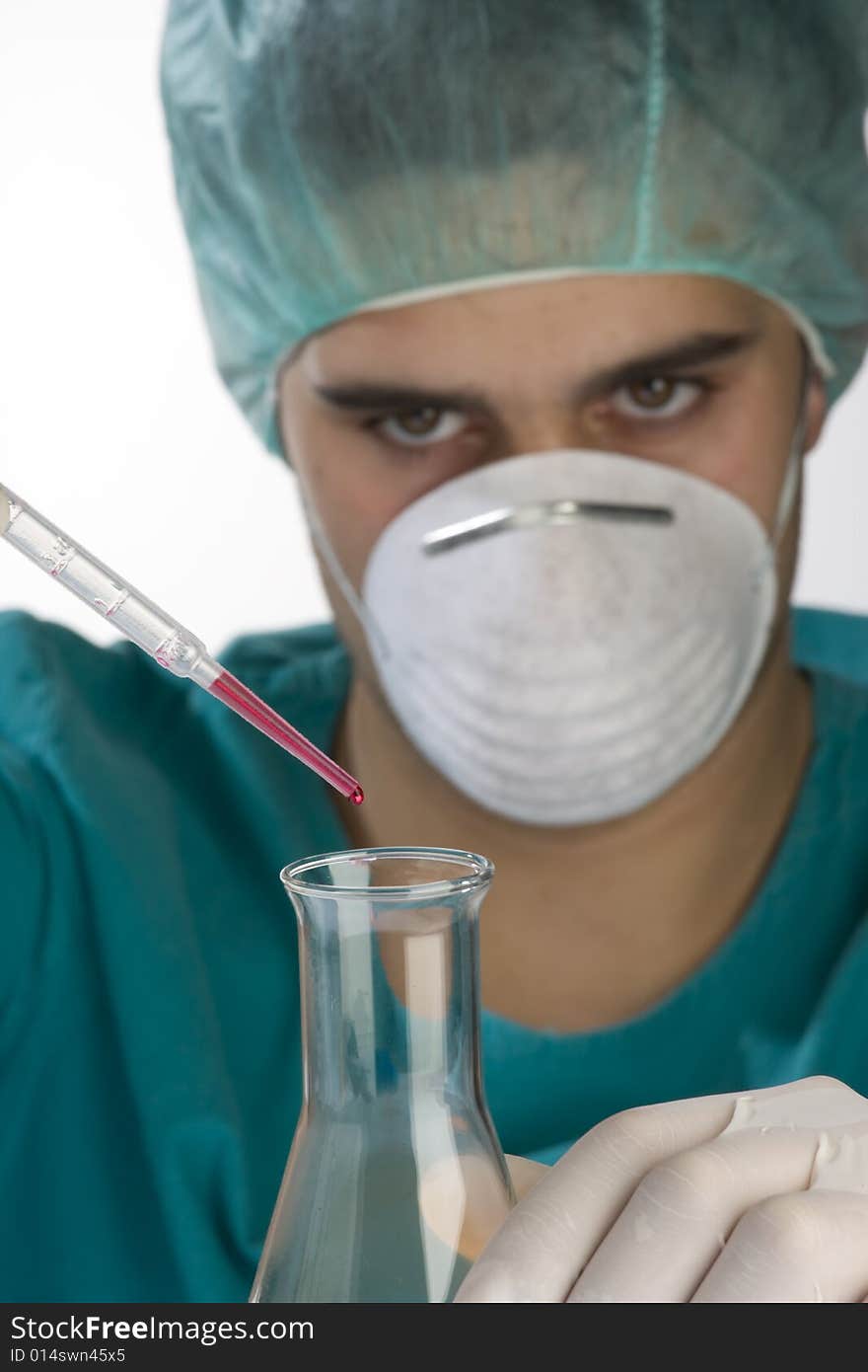 Scientist taking a probe in a labor scene with testtubes and beaker Shallow DOF the Focus is on the little bottle and the hand