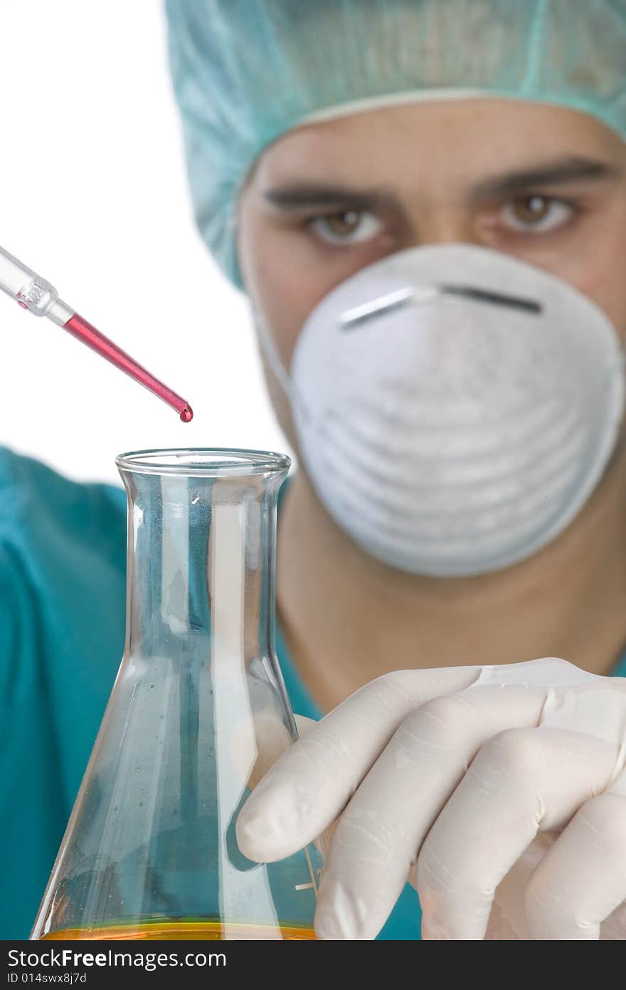 Scientist taking a probe in a labor scene with testtubes and beaker Shallow DOF the Focus is on the little bottle and the hand