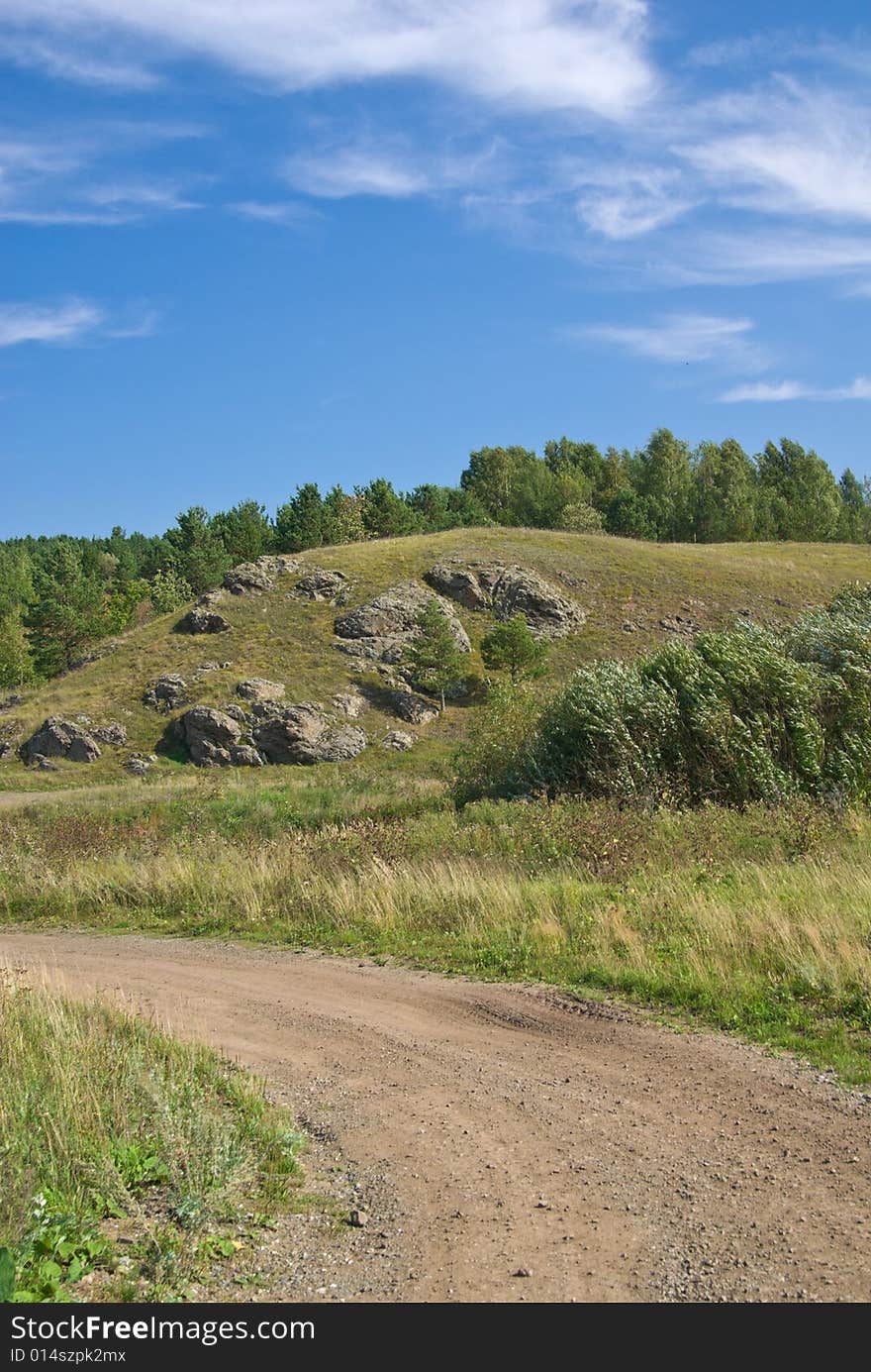 Landscape with earth road in the foreground.