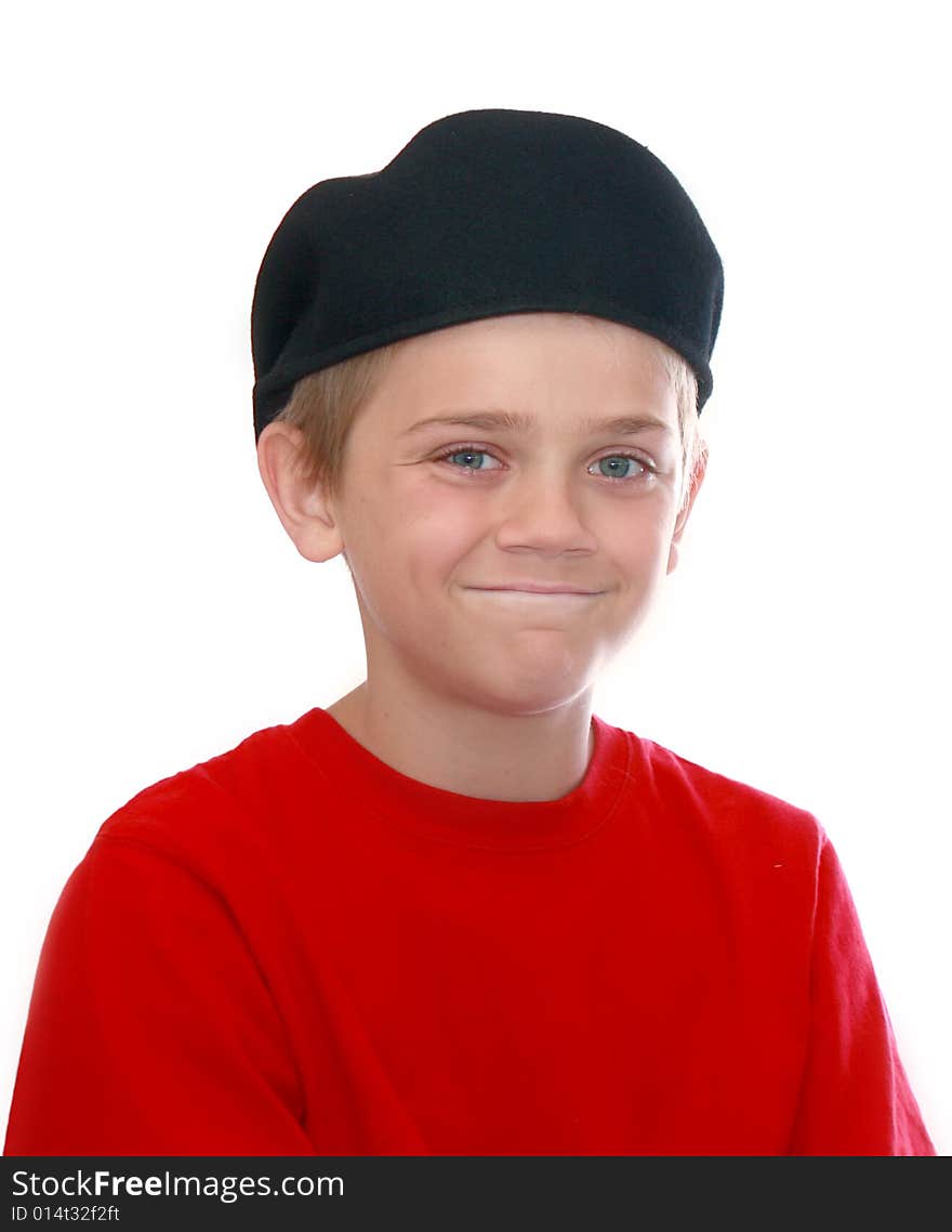 Cute young boy wearing a backwards cap and a red tee-shirt isolated on white. Cute young boy wearing a backwards cap and a red tee-shirt isolated on white.