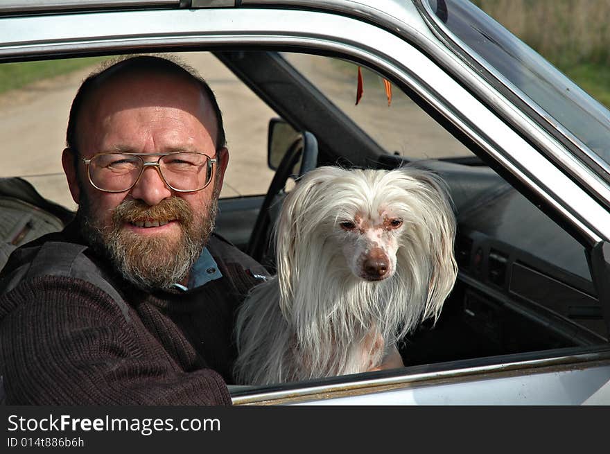 Man with dog in car