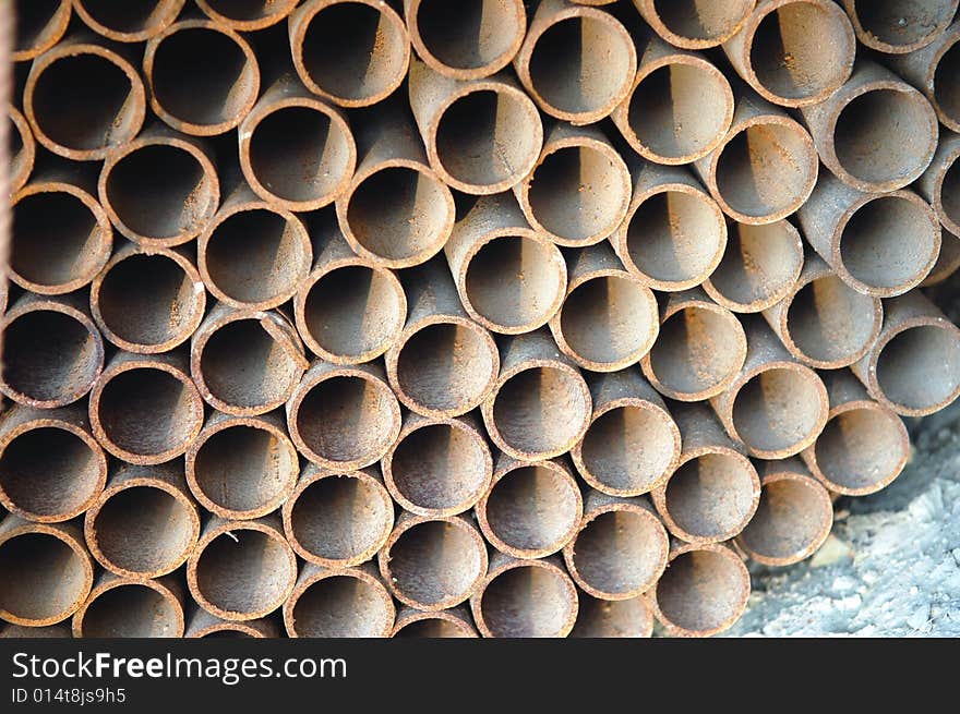 Abstract close up of a stack of steel pipes on construction site