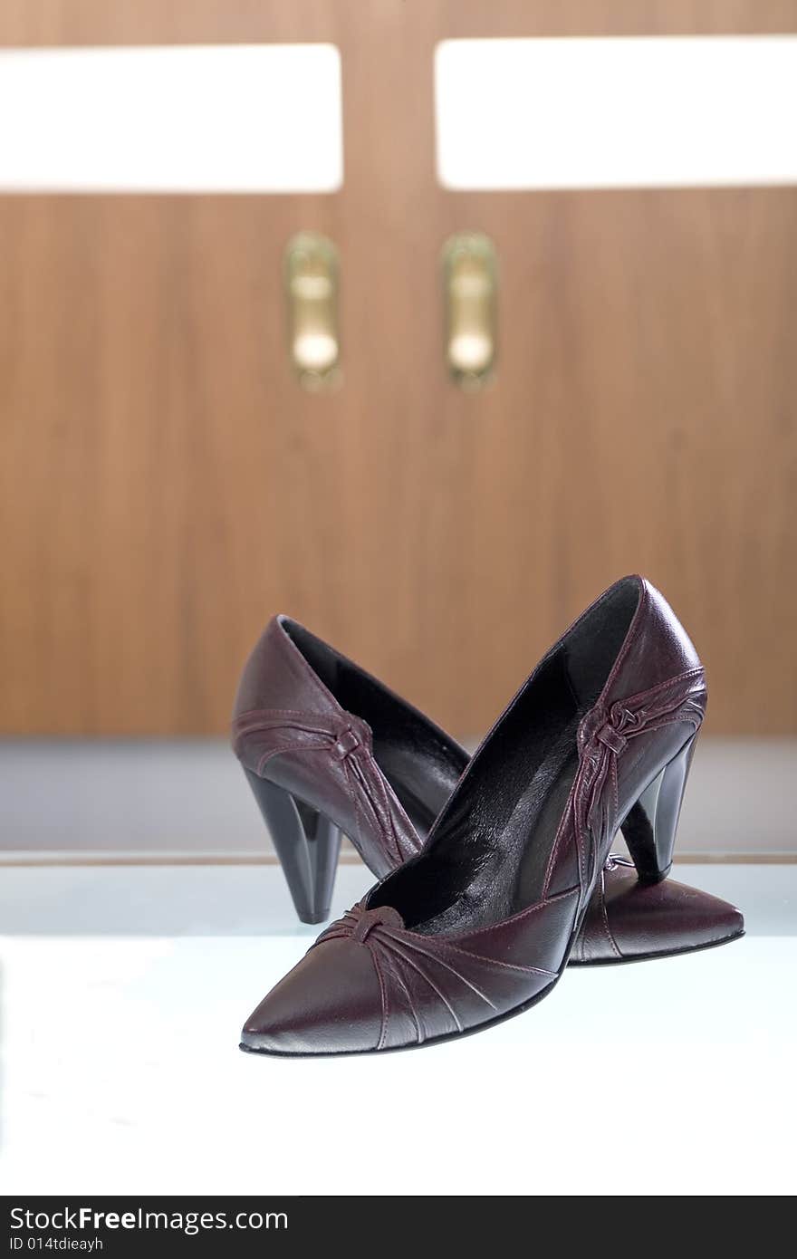 Photo of elegant shoes with glass and wood in the background. Photo of elegant shoes with glass and wood in the background