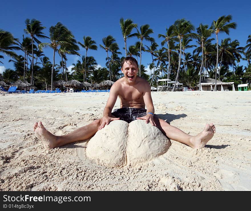 Men on the beach and sand sculpture. Men on the beach and sand sculpture